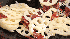 依次下香腸片、藕片翻炒均勻，加適量清水燜熟。