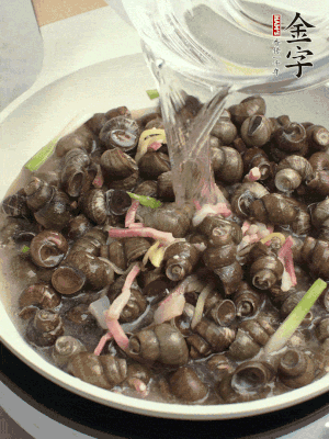 倒處理干凈的螺螄翻炒，加3勺料酒。加清水蓋過螺螄，中火蓋蓋煮5分鐘。