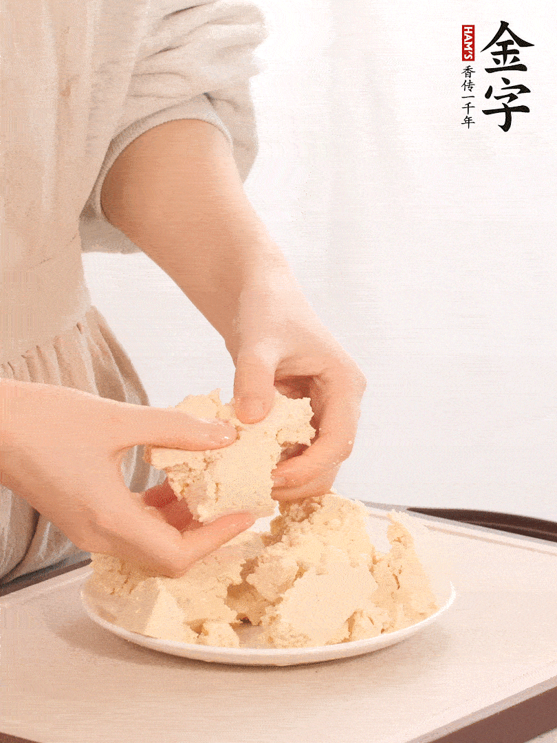 老豆腐用手掰成塊。